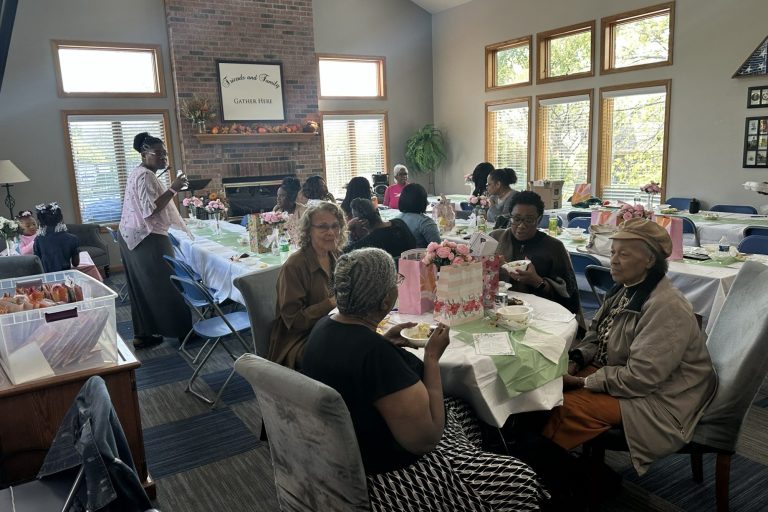 Stock Photo of women gathered around a table having a conversation